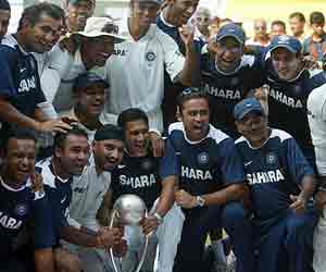 The Indian cricket team poses with a trophy after winning the fourth Test against Australia. India won the four Test-series 2-0.